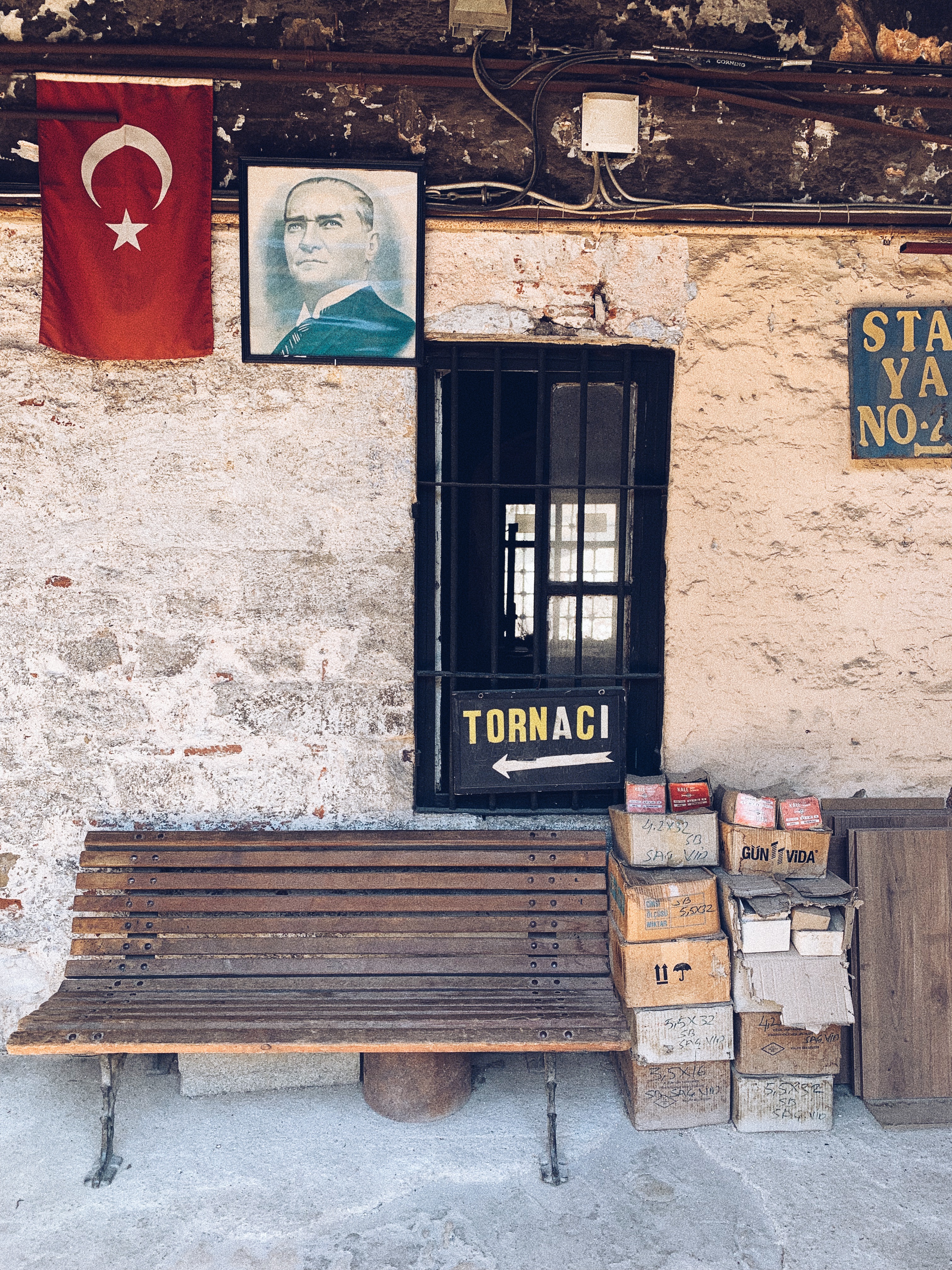 A poster of Atatürk and a turkish flag above a bench in Istanbul, Turkey